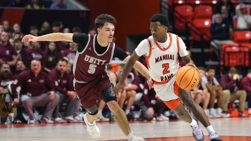 Peoria Manual’s Tahj Tolliver (2) moves the ball against Unity’s Brayden Henry (5) during the 2A semifinal game at State Farm Center.