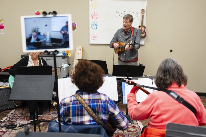 Carl Hix, the leader of the Hix Bros Ukulele Band, practices with members at Musical Expressions in Naperville, Saturday, Jan. 27, 2024.