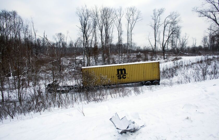 <small><strong>The charred remains of vehicles sits in a ravine along Interstate 94, Saturday, Jan. 10, 0215, as road crews work to clear them the day after a series of crashes closed the highway between mile markers 88 and 92 in eastern Kalamazoo County,