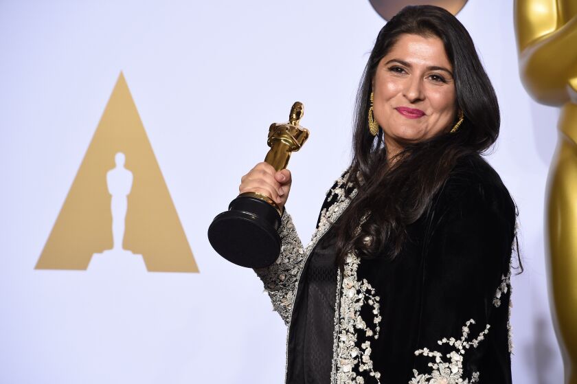 “A Girl in the River” director Sharmeen Obaid-Chinoy poses Feb. 28 with the Oscar she received for best documentary short subject.| FREDERIC J. BROWN/AFP/Getty Images