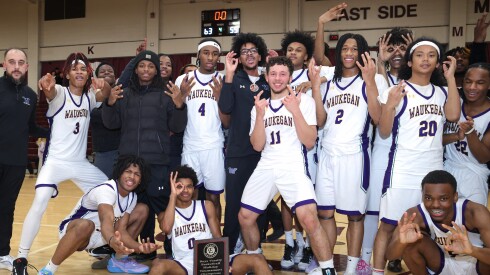 Waukegan celebrates winning the Elgin Holiday Tournament title game against Hersey.