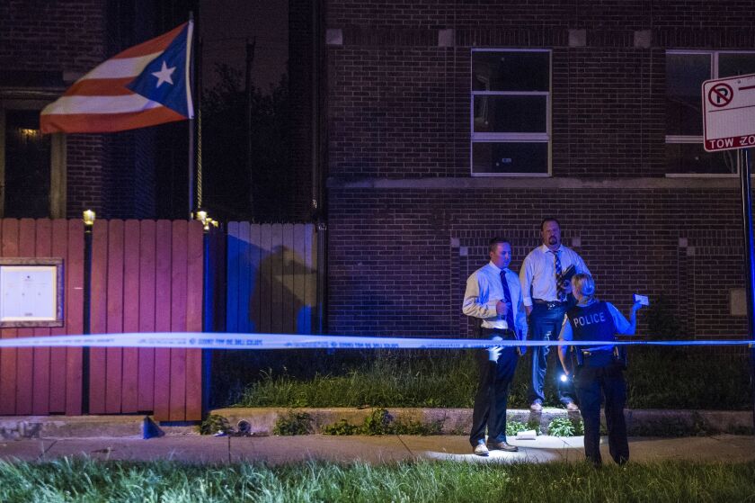 Police investigate a person shot Sunday night in the 1000 block of North Drake in Chicago. | Tyler LaRiviere/Sun-Times
