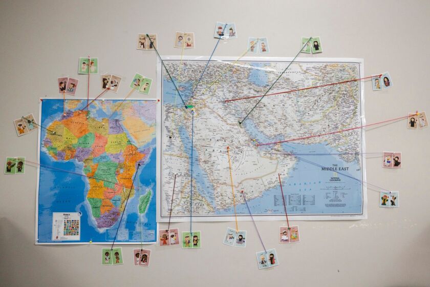 A classroom map traces different nationalities to their countries