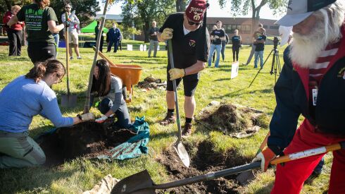 Volunteers plant trees at Shriners Children’s Chicago hospital on Tuesday.