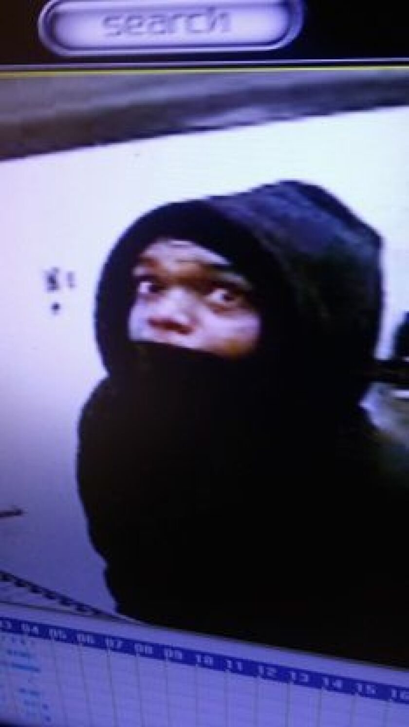 Surveillance photo from an armed robbery and beating at an Aurora convenience store. | Aurora police