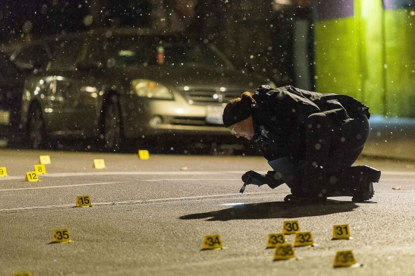 Chicago police investigate a scene where three people where wounded in a shooting Friday night in the 3400 block of West Ohio Street. | Tyler LaRiviere/Sun-Times