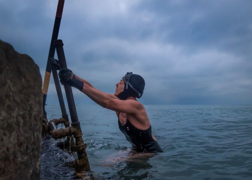 Lake Michigan Winter Swimming: Why, How One Brave Soul Does It in Chicago Alison Cuddy on the Lake Michigan Ladder. They learn that getting in and out of Lake Michigan when it's freezing outside is a delicate operation.