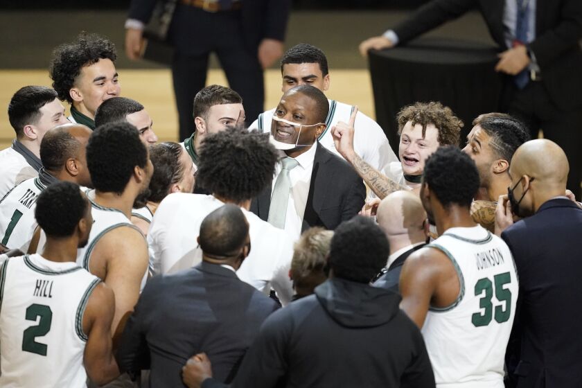 Cleveland State coach Dennis Gates celebrates with his team.