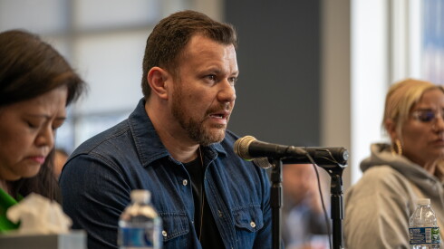 Marcos Carbajal speaks in front of a microphone at a hearing.