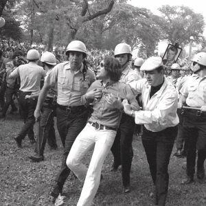 Police lead a demonstrator from Grant Park. | AP Photo