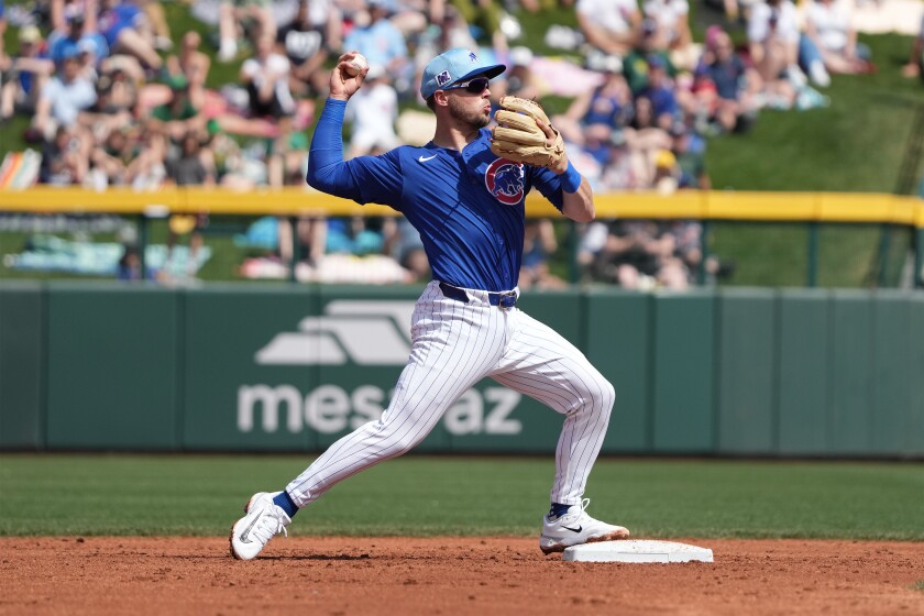 Nico Hoerner completes a double play of an infield grounder off the bat of Shea Langeliers in the top of the third inning during a spring training game at Sloan Park in Mesa, AZ, on March 23, 2025.