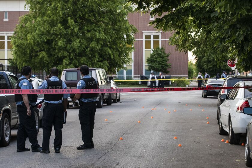 Chicago police investigate in the 700 block of North Spaulding Avenue, where a 40-year-old man was shot multiple times while he was riding in a car on the West Side on Memorial Day.