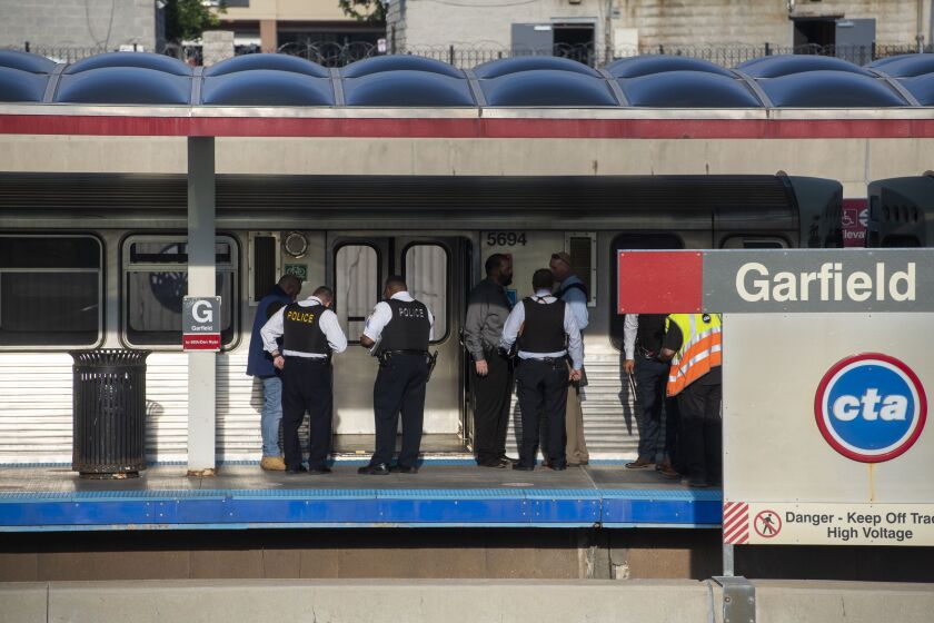 Chicago police work the scene where a person was shot and killed on a Red Line train in the 200 block of W. Garfield Blvd. in the Englewood neighborhood, Monday, Aug. 19, 2021.