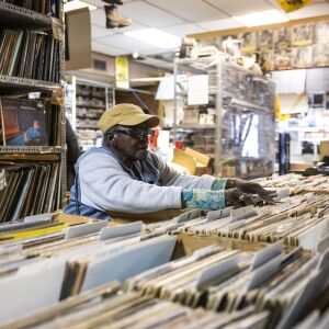 Marie Henderson, owner of Out of the Past Records, sorts vinyl records at her store in West Garfield Park.