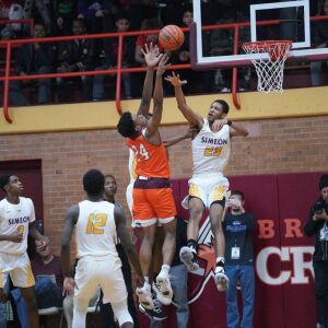 Brother Rice’s Marquise Kennedy (24) tries to put a shot up over Simeon’s Andre Casey Jr. (23), Friday 03-01-19. Worsom Robinson/For Sun-Times
