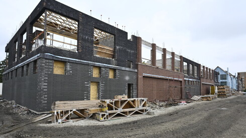 A dark black and brown structure that appears as if it in the middle of being built into a building.