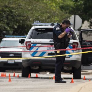 Chicago Police investigate at the 25th District station, 5555 W. Grand Ave., on the Northwest Side, after multiple officers were shot outside the station, Thursday morning, July 30, 2020. The suspect was also shot multiple times in the incident.