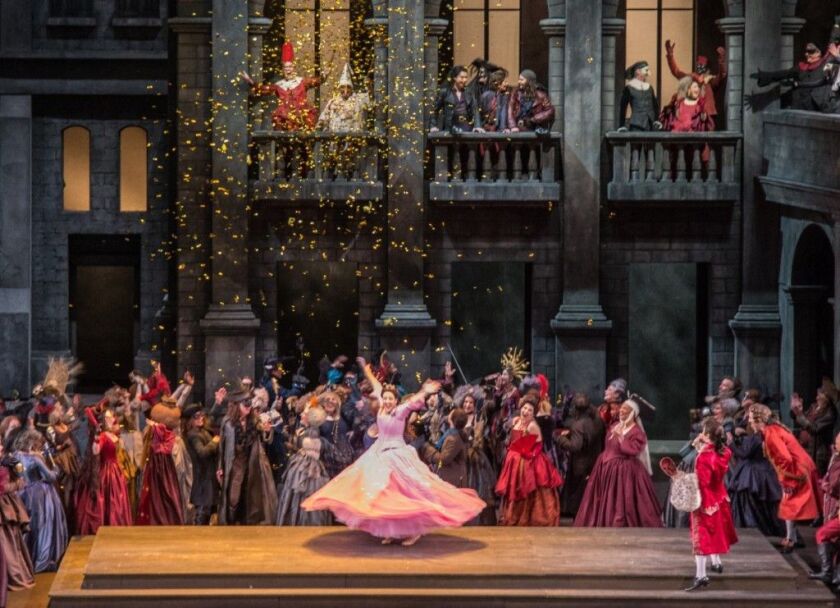 Susanna Phillips (center, in shocking pink gown) in a scene from the Lyric Opera production of Gounod’s “Romeo and Juliet.” (Photo: Andrew Cioffi)