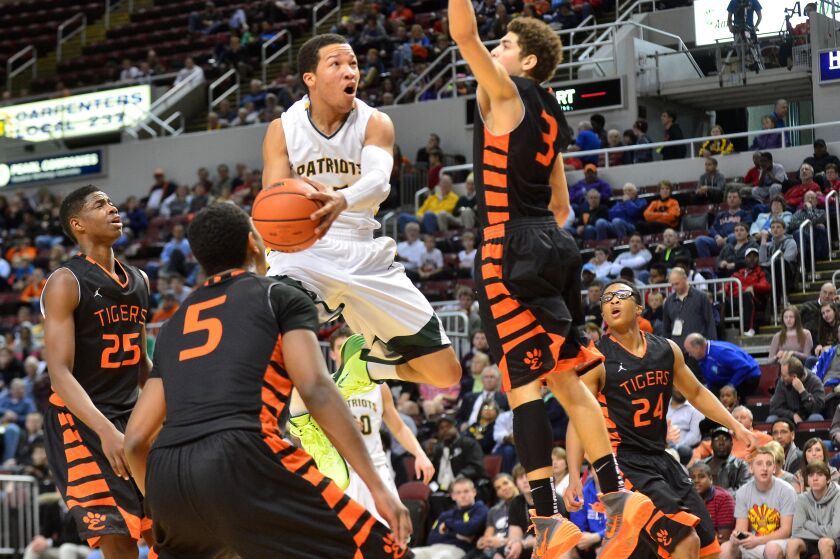 Jalen Brunson of Stevenson works the ball around Edwardsville defenders.