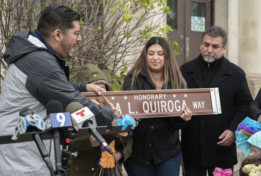 Ald. Carlos Ramirez-Rosa (35th) presented an honorary street sign to the family of Olga Quiroga on Thursday