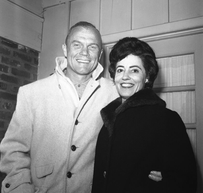 In this 1962 file photo, astronaut John Glenn poses with his wife, Annie, outside their Arlington, Virginia, home during his first news conference. 