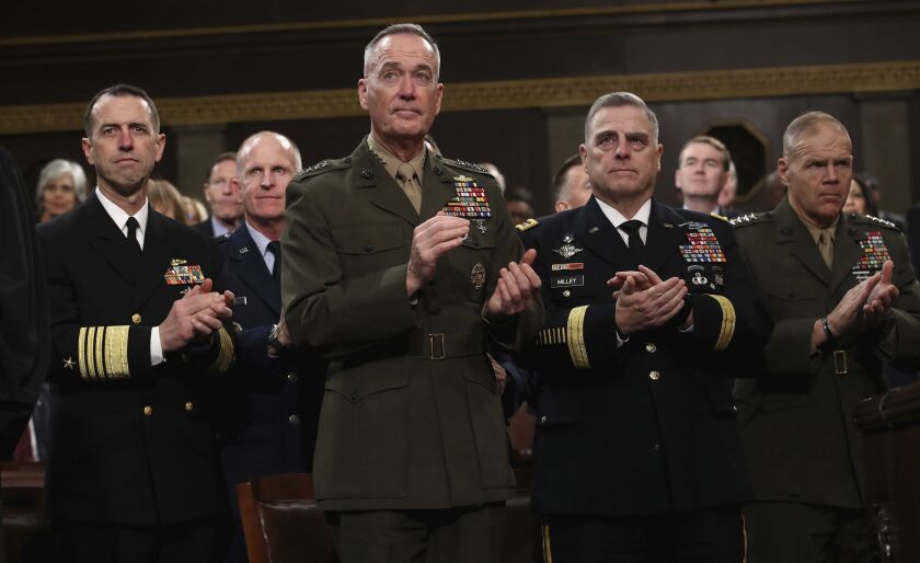 Chief of Naval Operations Adm. John Richardson, from left, Chairman of the Joint Chiefs of Staff Gen. Joseph Dunford, Chief of Staff of the Army Gen. Mark Milley, and Commandant of the Marine Corps Gen. Robert Neller listen as President Donald Trump deliv
