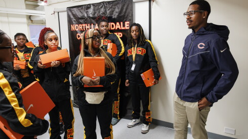Lenny Smith, Bears youth and high school football coordinator, speaks with members of North Lawndale Phoenix flag football team