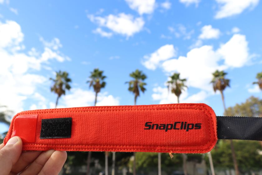 The product snaps around a barbell to secure weights. | Provided by Snapclips