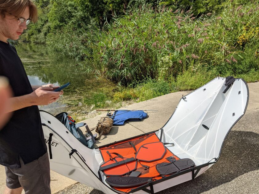 Sam Bowman does what his generation does and checks a YouTube video while setting up an Oru Inlet, a foldable kayak, at Mazonia State Fish and Wildlife Area. Credit: Dale Bowman