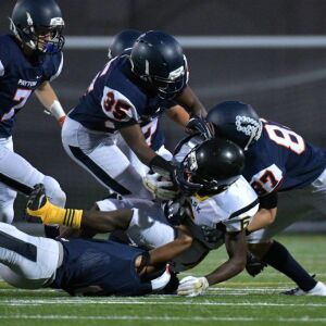 Clark’s Artez Kilgore (6) gets rapped up by Payton’s defense. Worsom Robinson/For the Sun-Times.