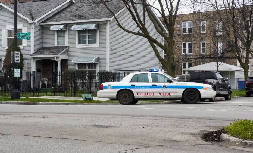 A Chicago Police Department squad car sits on a West Side street corner Friday morning.