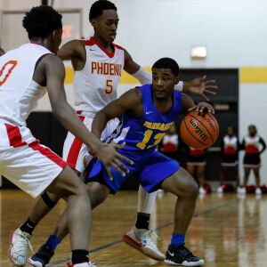 Farragut’s Malik Williams (13) moves the ball against North Lawndale’s Jamal Washington (5) and Jamar Wilkins (0).