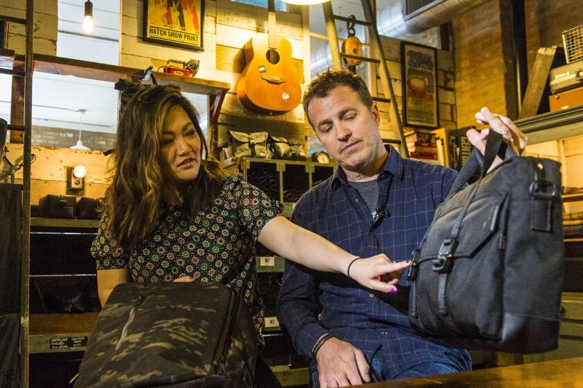 Ji Suk Yi with Chris Tag of Defy bags in Ravenswood. | Tyler LaRiviere/Sun-Times