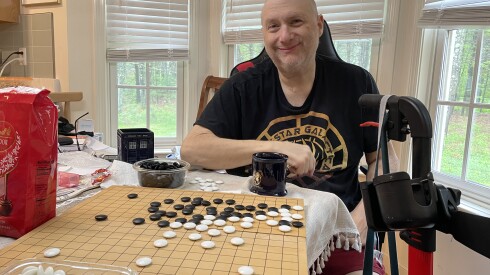My first cousin, Harrison Roberts, teaching me to play Go in 2024. He died of complications from kidney failure in August, after Mass General turned away. half a dozen potential donors.