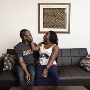 Celestine Mugisha and his wife, Winniefred Akello, embrace on the couch in their apartment in Rogers Park on the North Side, Jan. 30, 2020. Mugisha and Akello were married in Uganda in September 2016 and, days later, Mugisha moved to Chicago as part of the United States’ refugee resettlement program. More than three years later, Akello was also resettled through the program and the couple was reunited at O’Hare International Airport on Jan. 22, 2020.