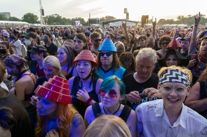 Festival-goers cheer as DEVO performs at the Riot Stage on the final day.