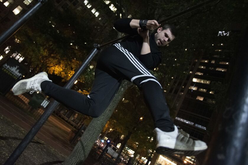 William Slotwinski practices the gimbarr move known as a sole, using calisthenics bars at Chicago’s public parks. After years of training, Slotwinski cannot picture his life without the strenuous sport.