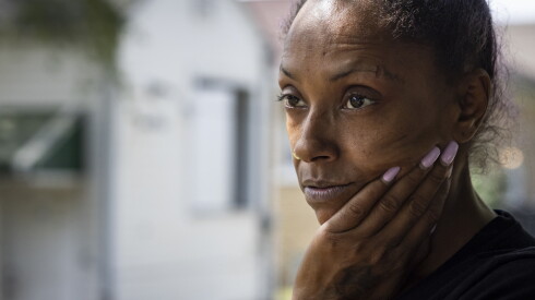 Melissa Dixon stands outside her home in Gary, Indiana, about a month after she and her family endured about two weeks with no lights during a historic power outage in the area, Tuesday, Sept. 15, 2026.