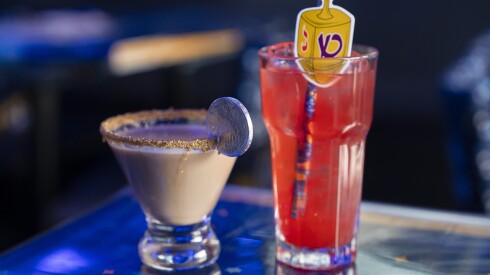 Gelt Martini (left), which contains vodka, Bailey’s chocolate and crème de cacao, and Maccabee Margarita, which is made of tequila, strawberry puree, triple sec, honey and lime juice, are served at 8 Crazy Nights, a Hanukkah-themed bar in Lake View, Saturday, Dec. 13, 2025.