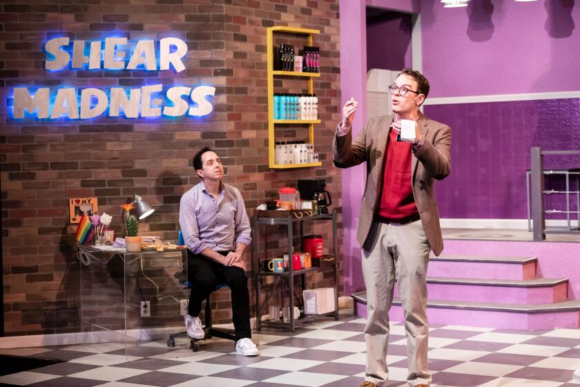 Salon owner Tony Whitcomb (Ed Kross, left) is questioned by detective Mikey Thomas (Sam Woods) in a scene from “Shear Madness” at the Mercury Theater.