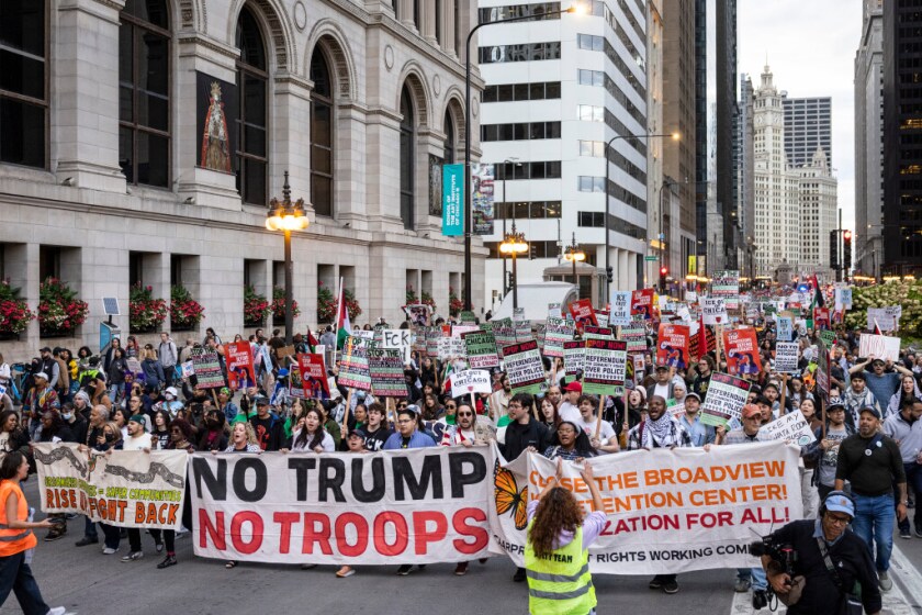 Demonstrators march through the Loop voicing opposition to Trump administration plans to increase ICE raids and send the federalized National Guard into Chicago.