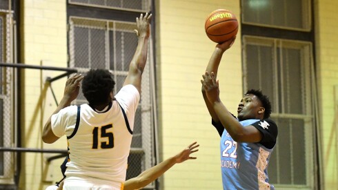 Kenwood’s Damari Stephens (22) shoots against Lincoln Park's Jalil Amous (15).