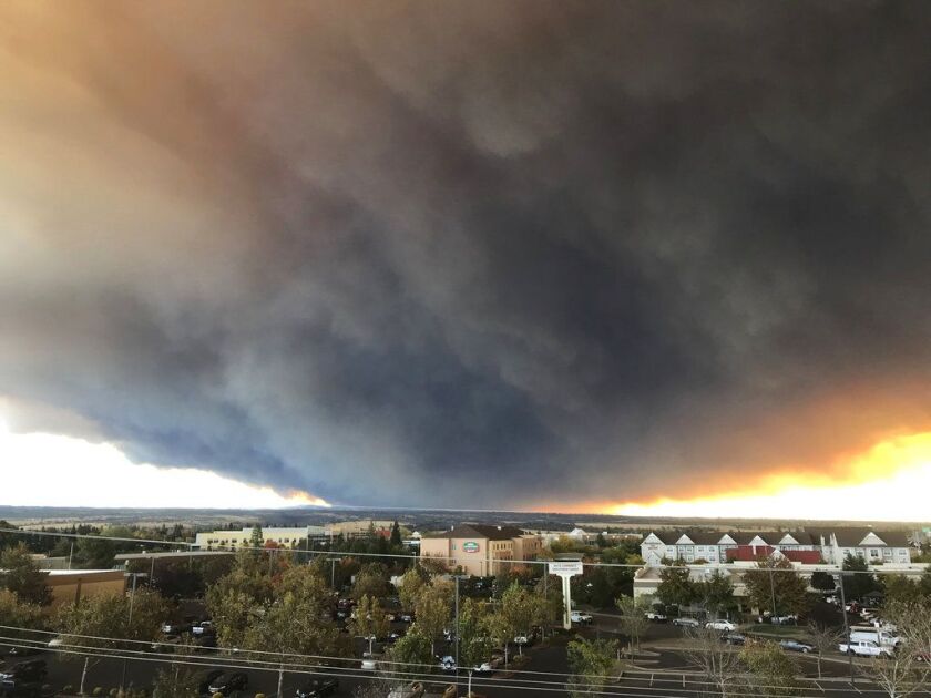 The massive plume from the Camp Fire, burning in the Feather River Canyon near Paradise, Calif., wafts over the Sacramento Valley as seen from Chico, Calif., on Thursday, Nov. 8, 2018. Authorities in Northern California have ordered mandatory evacuations