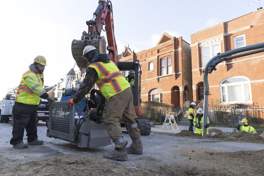 On the South Side, contractors move machinery used for boring underground as part of a new method of replacing lead service lines.