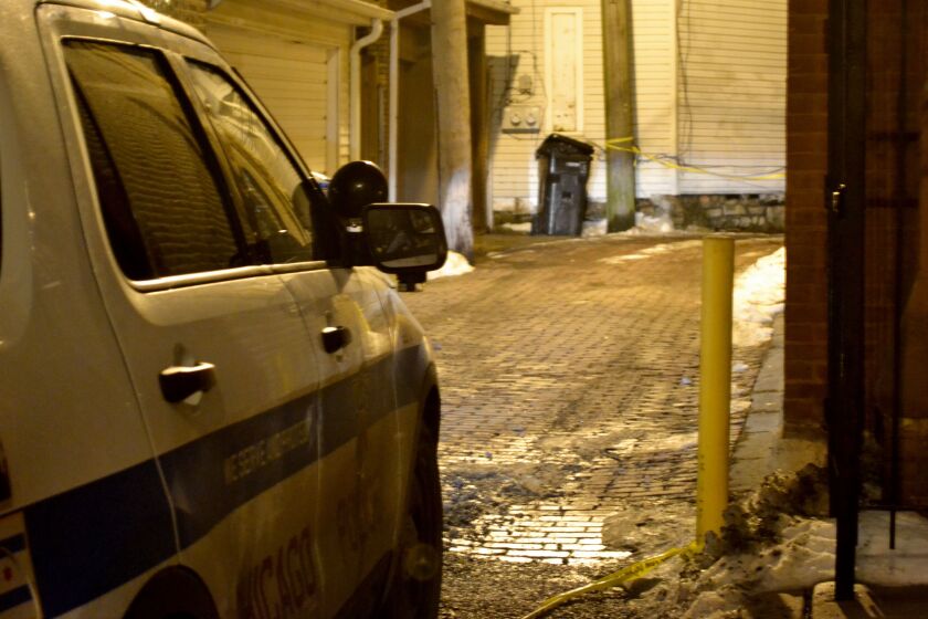 Chicago Police guard a Wicker Park alley early Friday after a 14-year-old boy was wounded in a drive-by shooting. | Justin Jackson/Sun-Times