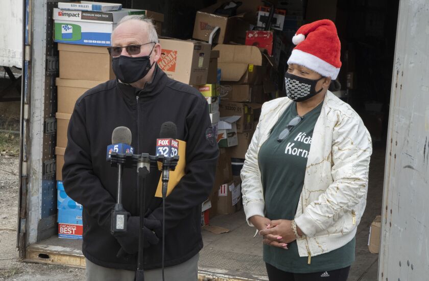 Joseph Vaccaro (left) and Delece Williams (right) speak about the recovery of the container holding holiday donations for Kidz Korna Thursday.