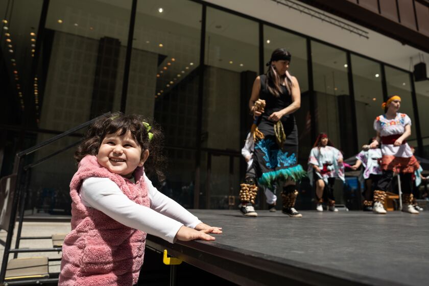 Yara Beltran, 3, smiles while watching members of Instituto Health Sciences Career Academy’s Aztec Dance program perform during a celebration of Mexico Week at Daley Plaza in the Loop, Tuesday, May 9, 2023. | Pat Nabong/Sun-Times