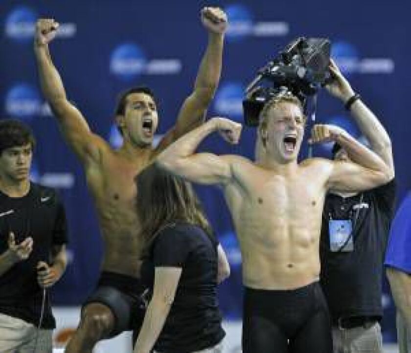 Southern California’s Reed Malone (right) and Dylan Carter (left) celebrate their team’s win in the men’s 800-yard freestyle relay during the NCAA Division I Championships on March 28 in Austin, Texas. | Michael Thomas/AP