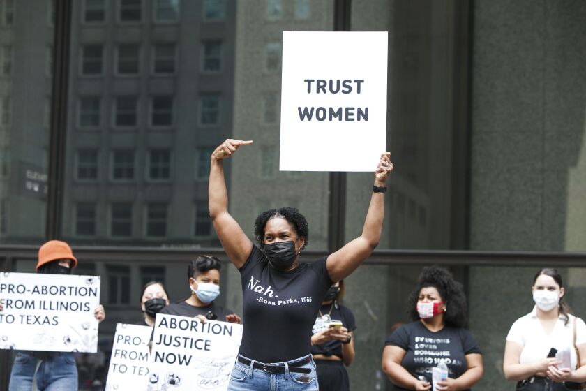 An abortion rights demonstrator holds a sign at the Daley Plaza during a protest earlier this month.