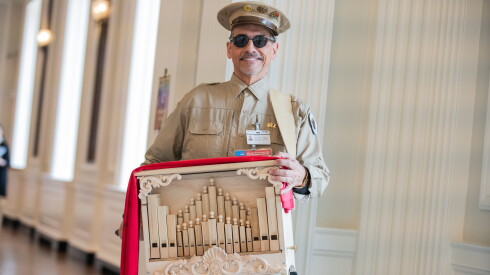 Juan Dies stands with his portable street organ
